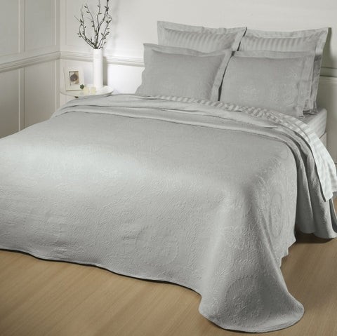 This is a grey bedspread showcasing the soft grey comforters, pillows, and additional hotel sheets.